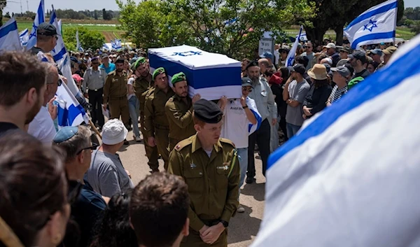 Israeli soldiers carry the casket of Israeli reserve Major Dor Zimel during his funeral in Even Yehuda, occupied Palestine, April 22, 2024. (AP)