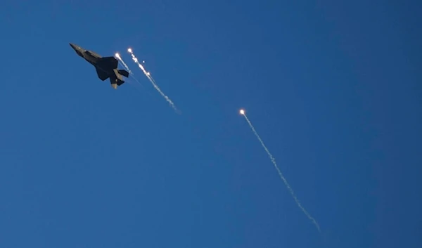 An Israeli air force F-35 war plane releases flares into the air in Hatzerim air force base near the southern occupied city of Bir al-Sabe, occupied Palestine, Thursday, June 23, 2022 (AP)