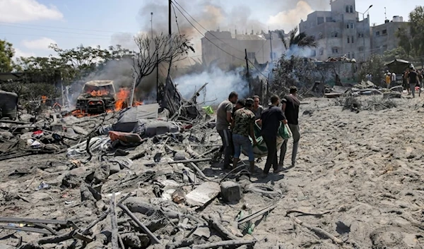 Palestinians evacuate a body from a residential builiding bombed by an Israeli warplanes on Khan Younis, southern Gaza Strip, Palestine, July 13,2024. (AP)