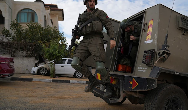 Israeli army investigators arrive at the site of the early morning attack of Israeli settlers, that left at least 18 burnt vehicles, on the outskirts of the West Bank city of al-Bireh on November 4, 2024. (AP)