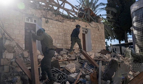 Israeli occupation forces check a house hit by a rocket fired from Lebanon on Saturday, in Haifa, 'Israel', Nov. 17, 2024. (AP)