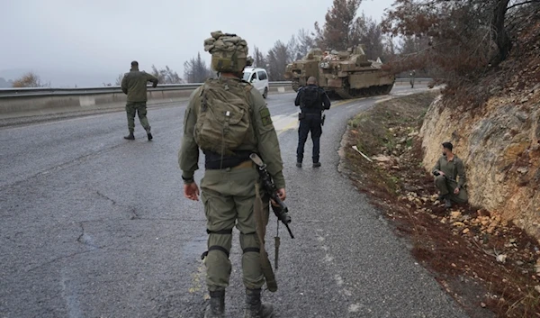 Israeli soldiers stop traffic during an alert of incoming rockets, near "Kiryat Shmona", northern Palestine, Sunday Nov. 24, 2024. (AP Photo/Ohad Zwigenberg)