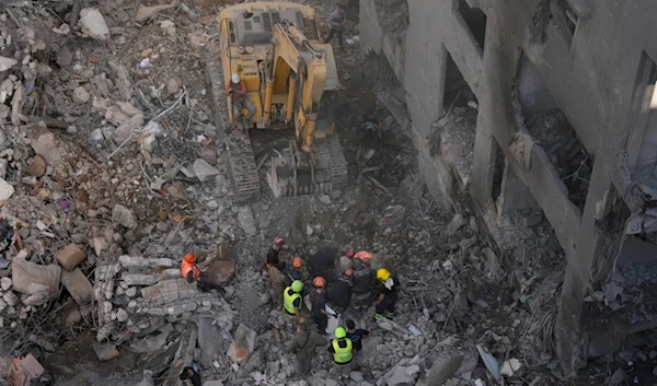 Rescue workers search for victims at the site of an Israeli occupation airstrike that hit central Beirut, Lebanon, Saturday, Nov. 23, 2024. (AP)