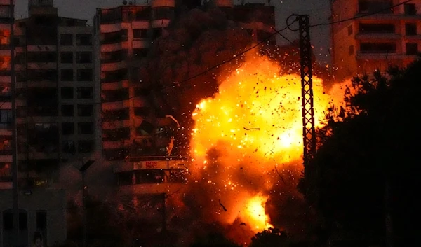 Thick smoke, flames and debris erupt from an Israeli airstrike that targeted a building in Tayouneh, Beirut, Lebanon, Monday, November 25, 2024 (AP)