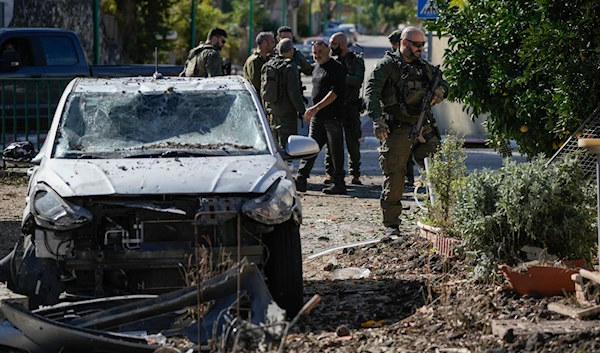 Israeli security officers and army soldiers inspect the site where a rocket fired from Lebanon landed in a backyard in Kiryat Shmona, northern "Israel", on November 26, 2024. (AP)