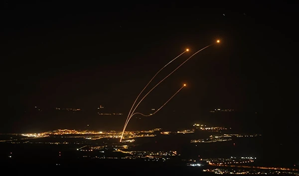 The Israeli Iron Dome air defense system fires to try and intercept rockets launched from Lebanon, near Kiryat Shmona, as seen from the Israeli-occupied Syrian Golan Heights, Oct. 26, 2024. (AP)