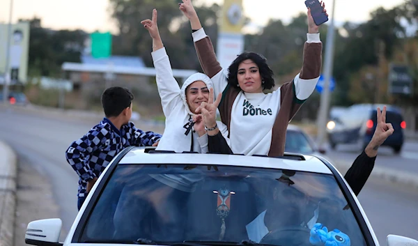 People celebrate after the ceasefire between "Israel" and Hezbollah went into effect, in Saida. (AP)