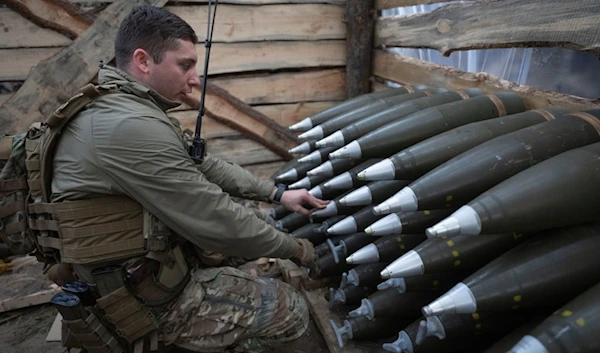 A Ukrainian officer of the 92nd separate assault brigade inspects ammunition in a shelter on the frontline near Vovchansk, Kharkiv region, Ukraine, Monday, Oct. 28, 2024. (AP Photo/Efrem Lukatsky)