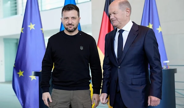 Ukraine's president Volodymyr Zelenskyy and German chancellor Olaf Scholz leave after a statement at the chancellery in Berlin, Germany, Friday, Oct. 11, 2024. (AP)