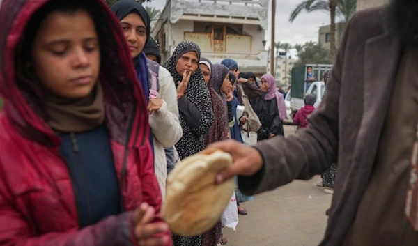 Palestinian women and children queue for bread in Deir al-Balah, Gaza Strip, Thursday, November 28, 2024 (AP)