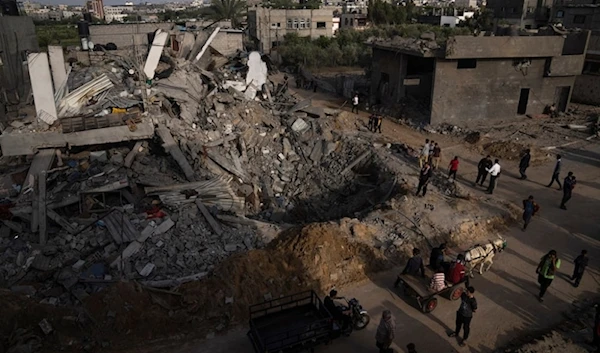 Palestinians inspect the rubble caused by an Israeli airstrike on house in Beit Lahia, northern Gaza Strip