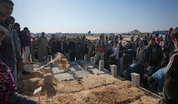 The graves of three children from the same family killed during an Israeli army strike are covered during their burial in Khan Younis, Gaza Strip, Thursday, November 21, 2024. (AP)