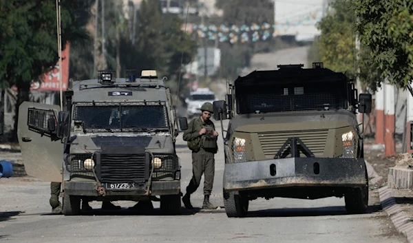 An Israeli occupation soldier stands by a vehicles during a military operation in the West Bank of Jenin, occupied West Bank, Palestine, Nov. 20, 2024. (AP)