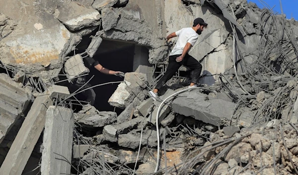 People search for victims at a destroyed building hit in an Israeli airstrike, in Ghaziyeh town, south Lebanon, Sunday, November 3, 2024 (AP)