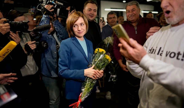 Moldova's President Maia Sandu celebrates with supporters as preliminary results are announced for the presidential election runoff in Chisinau, Moldova, on November 3, 2024. (AP)