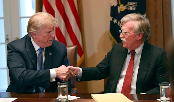 President Donald Trump, left, shakes hands with national security adviser John Bolton in the Cabinet Room of the White House in Washington, April 9, 2018 (AP)