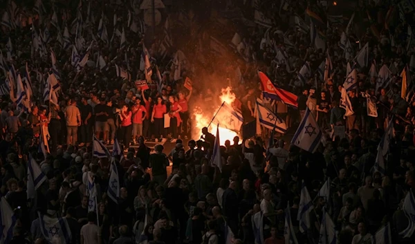 Israelis light a bonfire during a protest after Prime Minister Benjamin Netanyahu has dismissed his popular minister Yoav Gallant, in Tel Aviv, Tuesday, Nov. 5, 2024. (AP)