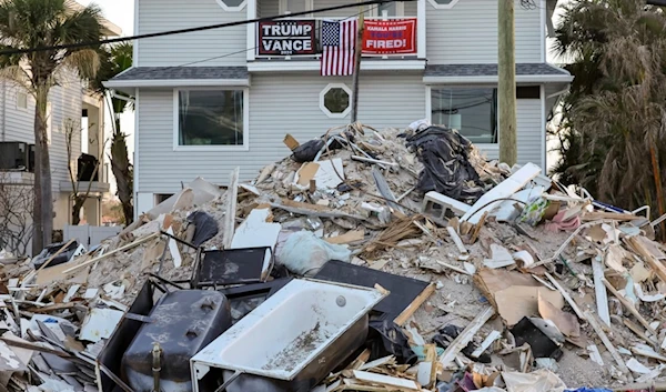 Debris remains on the streets following Hurricanes Helene and Milton as Floridians vote in the general election on Tuesday, Nov. 5, 2024, in Treasure Island, Fla. (AP Photo/Mike Carlson)