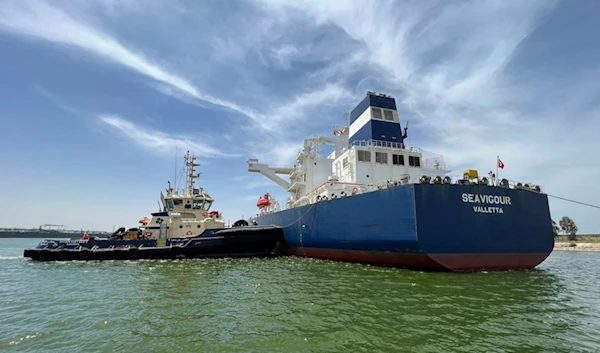 In this photo provided by Egypt's Suez Canal Authority, a tugboat pushes the Malta-flagged Seavigour after it suffered a mechanical malfunction at the 12 kilometers (7.5 miles) mark of the canal, Egypt, Sunday, June 4, 2023 (AP)