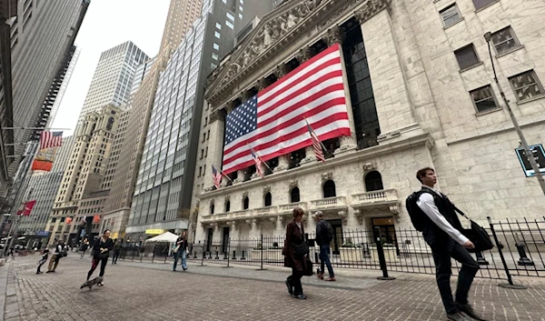 People pass the New York Stock Exchange in New York's Financial District on Tuesday, November 5, 2024 (AP)