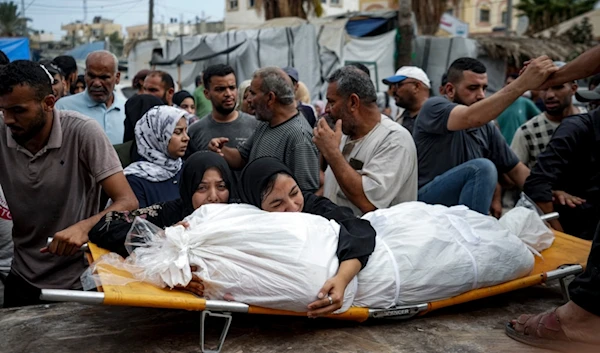 Palestinian women mourn a relative killed in the Israeli bombardment of the Gaza Strip, at a hospital in Deir al-Balah, Thursday, Aug. 22, 2024. (AP)