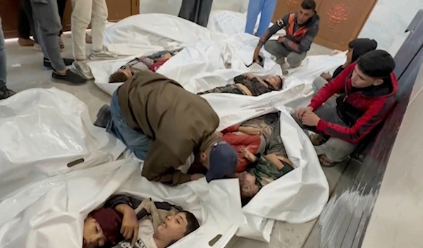 A Palestinian kisses a relative killed in Israeli airstrikes, in a morgue in the city of Khan Younis, southern Gaza Strip, Friday, Oct. 25, 2024. (AP Photo)