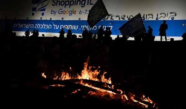 Israelis block a highway during a protest after Prime Minister Benjamin Netanyahu has dismissed Security minister Yoav Gallant, in Tel Aviv, occupied Palestine, Tuesday, Nov. 5, 2024. (AP)