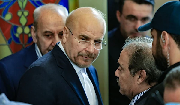 Iran's Parliament Speaker Mohammad Bagher Qalibaf (2-L)) and his Lebanese counterpart Nabih Berri (L) walk together after their meeting in Beirut on October 12, 2024. (AFP)