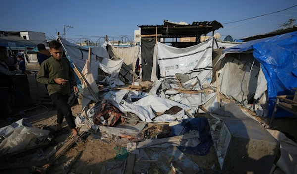 A Palestinian walks through the site of an Israeli strike in the courtyard of the la-Aqsa Martyrs Hospital in Deir al-Balah, Gaza Strip, Saturday, November 9, 2024 (AP)