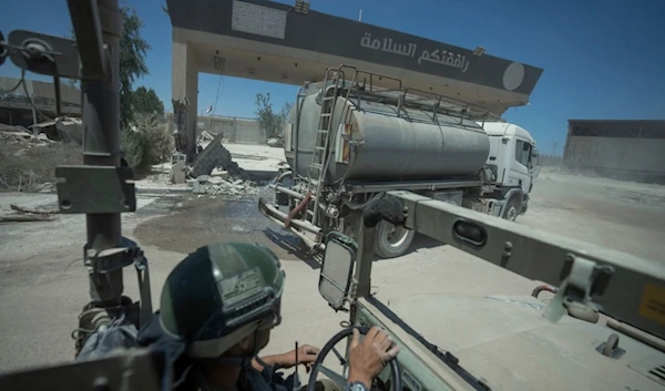 An Israeli soldier drives on the Gaza side of the Karem Abu Salem crossing between "Israel" and the Gaza Strip, Wednesday, July 3, 2024. (AP)