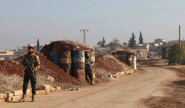 Terrorists stand guard in Kafr Halab, Aleppo countryside, Syria, Friday, Nov. 29, 2024 (AP)