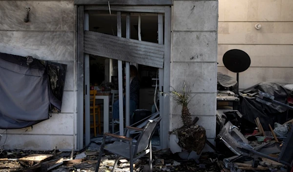 Some damage is seen at the site where a drone launched from Yemen slammed into an apartment in Yavne, central occupied Palestine, Monday, December 9, 2024 (AP)