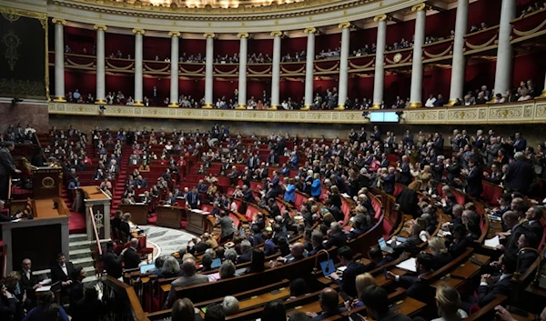 Lawmakers convene at the National Assembly during a debate on Wednesday, Dec. 4, 2024 in Paris. (AP Photo/Michel Euler)