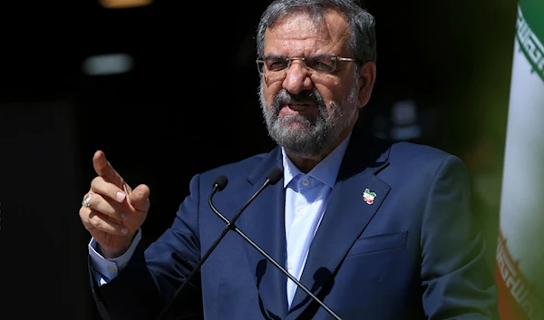 Mohsen Rezaei speaks with state-run TV journalists upon arrival to attend the final debate of the candidates, at a state-run TV studio in Tehran, Iran, on June 12, 2021. (AP)