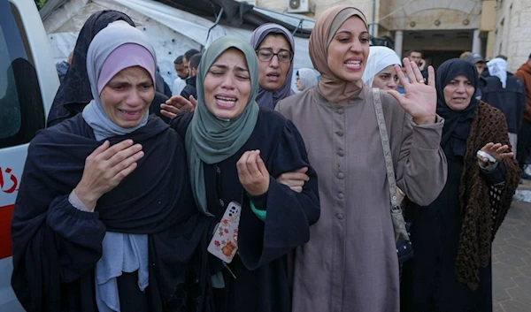 Palestinian women mourn over victims following an Israeli bombardment, at the al-Aqsa Martyrs Hospital in Deir al-Balah, Gaza Strip, Sunday, December 8, 2024 (AP)