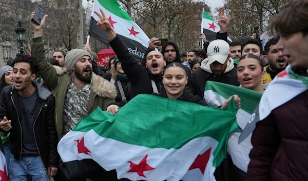 Syrians living in France gather on Republique Square after the Syrian government fell, Sunday, Dec. 8, 2024, in Paris (AP)