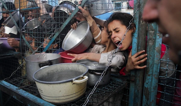 Palestinians line up to receive free meals at Jabaliya refugee camp in the Gaza Strip on March 18, 2024. (AP)