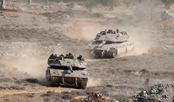 Israeli tanks maneuver next to the security fence near the so-called Alpha Line that separates the occupied Golan Heights from Syria, in the town of Majdal Shams, Wednesday, December 11, 2024 (AP)