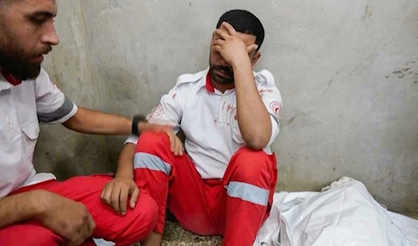 Screen grab from Associated Press video shows medic Abed al Aziz Bardini mourns next to the body of his mother on October, 2024 , in Dier al-Balah in Gaza Strip. (AP)