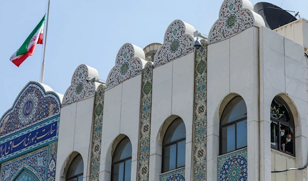 Iran's flag is flown at half-mast at the Iranian embassy in Damascus on May 20, 2024, following the death of Iran's President alongside his Foreign Minister and others in a helicopter crash. (AFP)