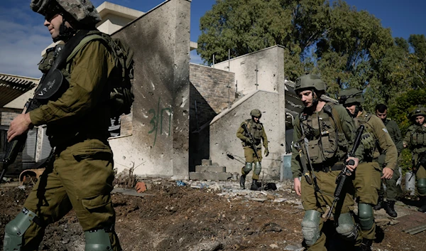 Israeli soldiers inspect the site where a rocket fired from Lebanon landed in a backyard in Kiryat Shmona, northern "Israel", on November 26, 2024. (AP)