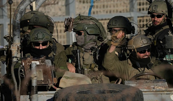 Israeli soldiers stand on an armored vehicle after crossing the security fence near the so-called Alpha Line that separates the Israeli-occupied Golan Heights from Syria, in the town of Majdal Shams, Monday, December 16, 2024 (AP)