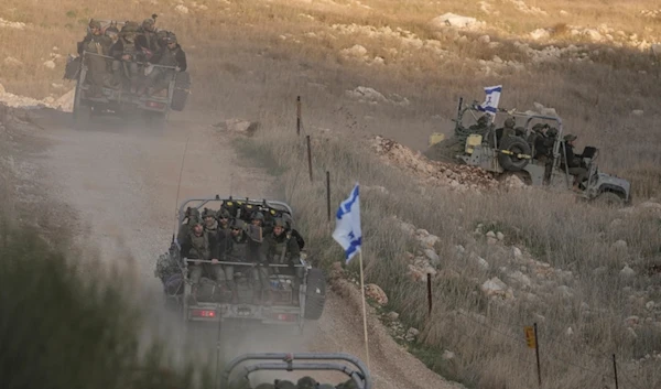 Israeli occupation soldiers cross the security fence moving towards the so-called Alpha Line that separates the Israeli-annexed Syrian Golan Heights from Syria, in the town of Majdal Shams, Dec. 15, 2024. (AP)