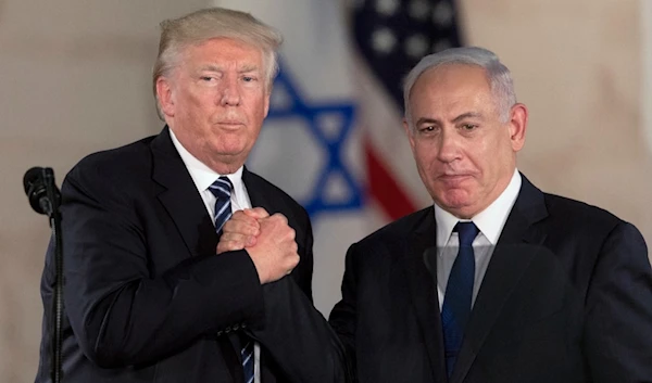 Then-President Donald Trump and Israeli occupation Prime Minister Benjamin Netanyahu shake hands in al-Quds, May 23, 2017. (AP)