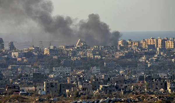 Smoke rises following an explosion in the Gaza Strip as seen from occupied Palestine, Wednesday, Dec.18, 2024. (AP Photo/Ohad Zwigenberg)