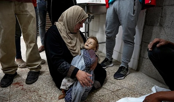 A Palestinian mother mourns her child killed in an Israeli bombardment of the Gaza strip at a morgue in Deir al-Balah, on October 2,2024. (AP)