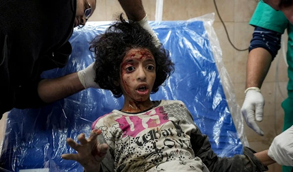 A Palestinian child wounded during the Israeli bombardment of the Gaza Strip receives treatment at the Al-Aqsa Hospital in Deir al-Balah, Thursday, Dec. 19, 2024. (AP)