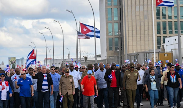 Cuban President Miguel Diaz-Canel, third left, and former President Raul Castro, fourth left, march against the U.S. embargo and demand Cuba's removal from the list of countries that sponsor terrorism, in Havana, Cuba, on December 20, 2024. (AP)