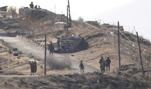 A Syrian man left waves a white flag as he approaches Israeli occupation forces in Maaria village on Thursday December 19,2024.(AP)