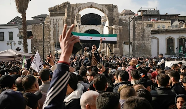 man shouts as others celebrate the fall of Bashar al-Assad's government after Friday prayers at the Umayyad Mosque in Damascus, Syria, Friday, Dec. 20, 2024. (AP)